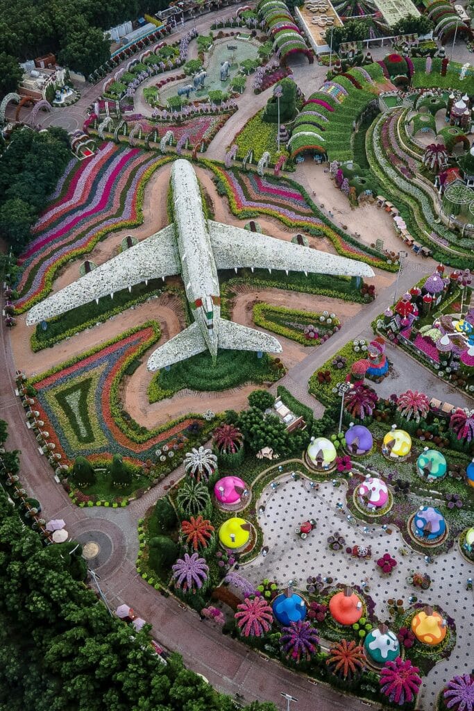 Stunning aerial shot of Emirates plane sculpture covered in flowers at Dubai Miracle Garden.