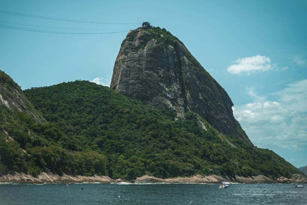 Breathtaking landscape of Sugarloaf Mountain near Rio de Janeiro with ocean and lush greenery.