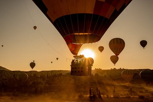 Scenic view of hot air balloons floating over Cappadocia, Turkey at sunrise.