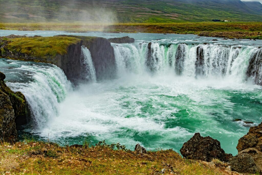 Stunning view of Godafoss waterfall cascading in Iceland's lush landscape.