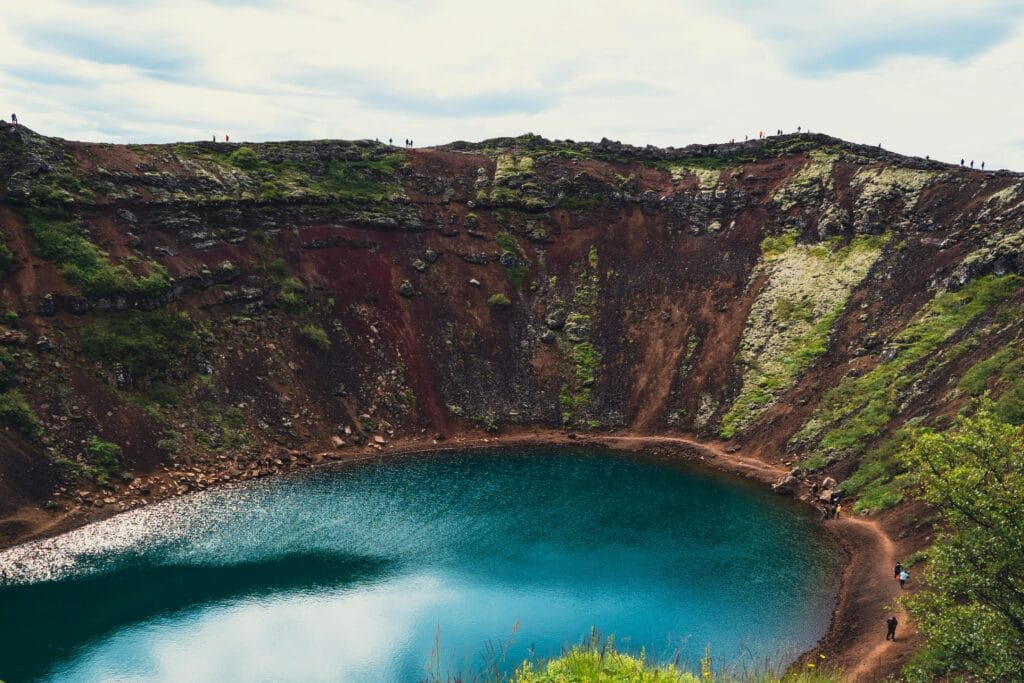 Breathtaking view of Kerid Crater's deep blue lake amidst Iceland's rugged landscape.