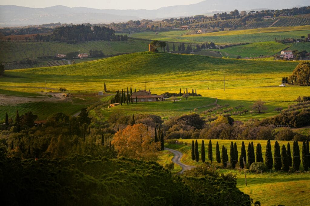 Breathtaking aerial view of the rolling hills in Tuscany, Italy, during sunset.